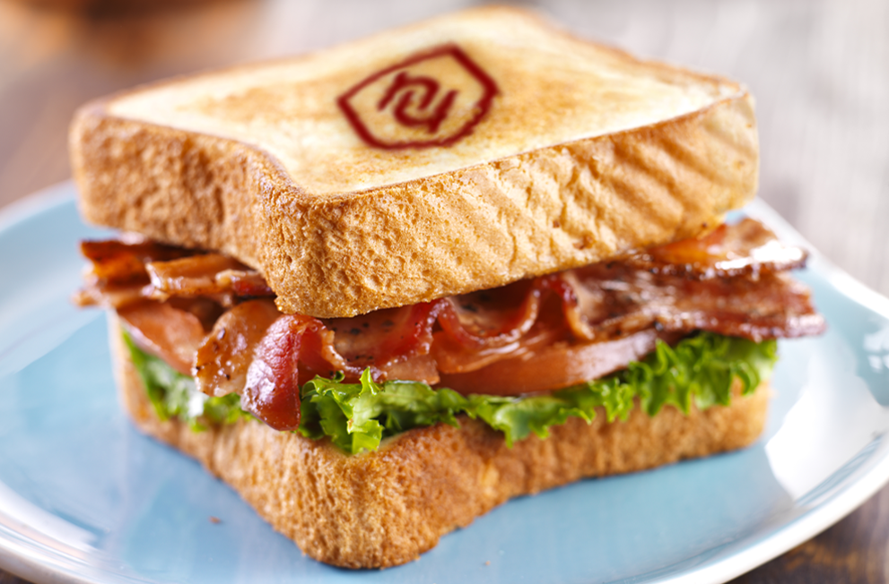 Bacon, lettuce and tomato sandwich with the Hooyu logo toasted into the bread on top.